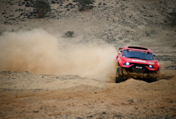 Dust busters: Sebastien Loeb and co-driver Daniel Elena test out their car ahead of the 2021 Dakar Rally