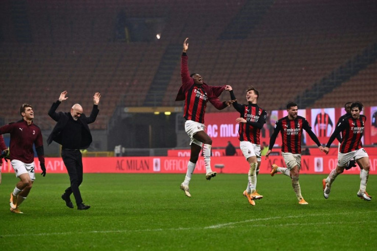 AC Milan coach Stefano Pioli (2ndL) and players celebrate after ending the year top of Serie A.