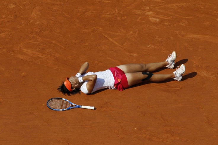 Li Na of China reacts after winning her women&#039;s final against Francesca Schiavone of Italy at the French Open tennis tournament at the Roland Garros stadium in Paris.