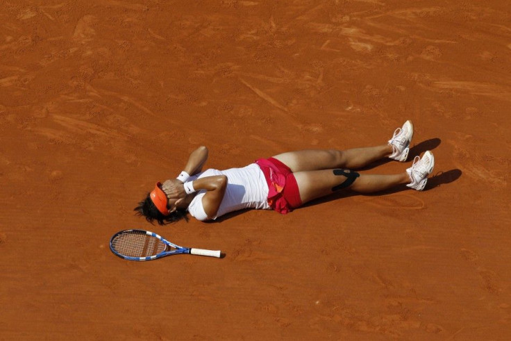 Li Na of China reacts after winning her women's final against Francesca Schiavone of Italy at the French Open tennis tournament at the Roland Garros stadium in Paris.
