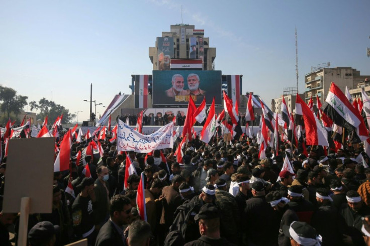 Iraqi demonstrators rally in Baghdad's Tahrir Square to mark one year since a US drone strike killed Iran's revered commander Qasem Soleimani and his Iraqi lieutenant Abu Mahdi al-Muhandis