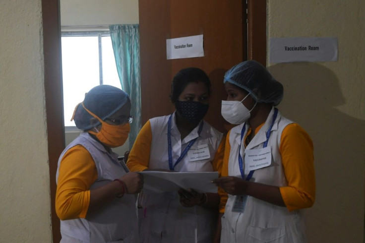 Health officials check details during a drill ahead of coronavirus vaccine delivery at a health centre in Kolkata, India on January 2, 2021