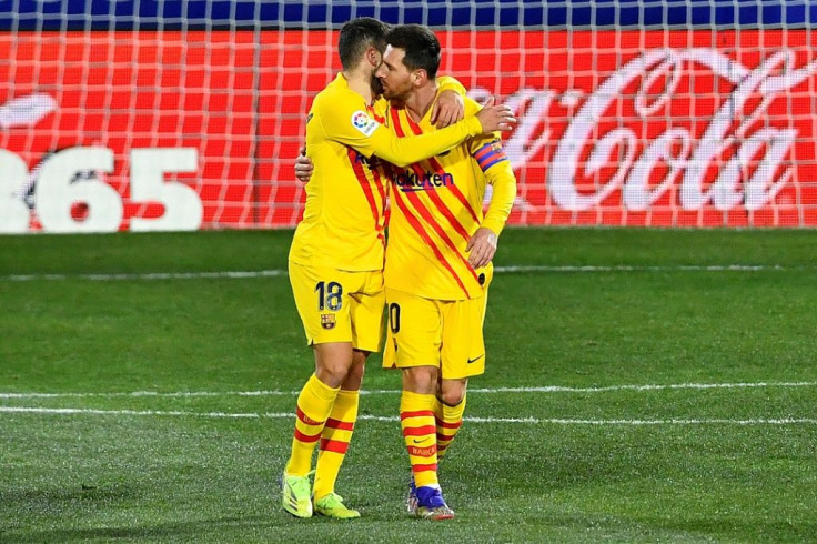Lionel Messi and Jordi Alba celebrate Barca's opening goal against Huesca