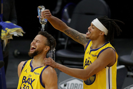  Stephen Curry #30 of the Golden State Warriors is showered in water by Damion Lee #1 of the Golden State Warriors