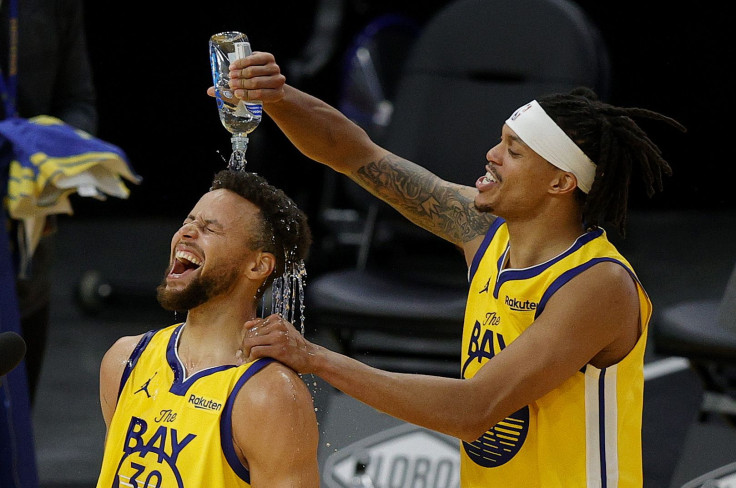  Stephen Curry #30 of the Golden State Warriors is showered in water by Damion Lee #1 of the Golden State Warriors