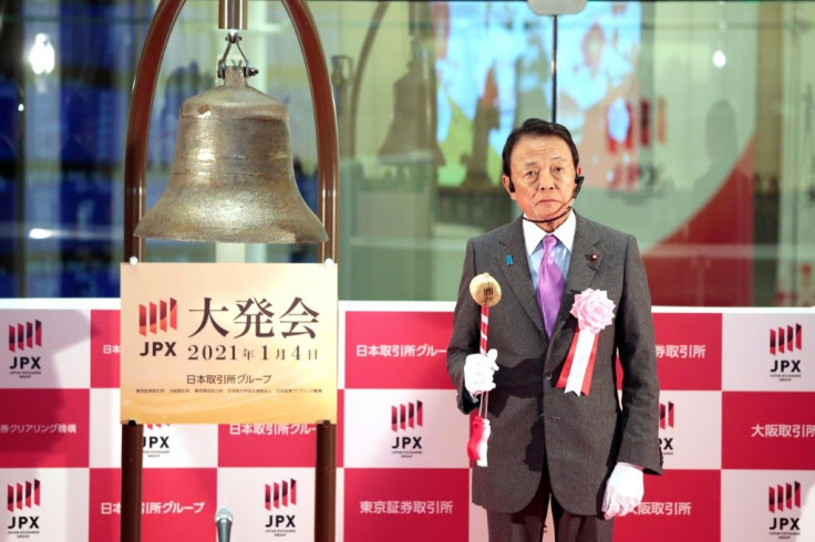 Japanâs Finance Minister Taro Aso readies to ring the bell to start the first day of trading of the new year at the Tokyo Stock Exchange