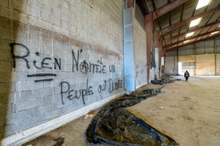 Graffiti reading "nothing can stop people dancing" inside one of the hangars