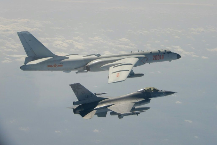 A handout photo taken and released on February 10, 2020 by Taiwan's Defence Ministry shows a Taiwanese F-16 fighter jet (bottom) flying next to a Chinese H-6 bomber