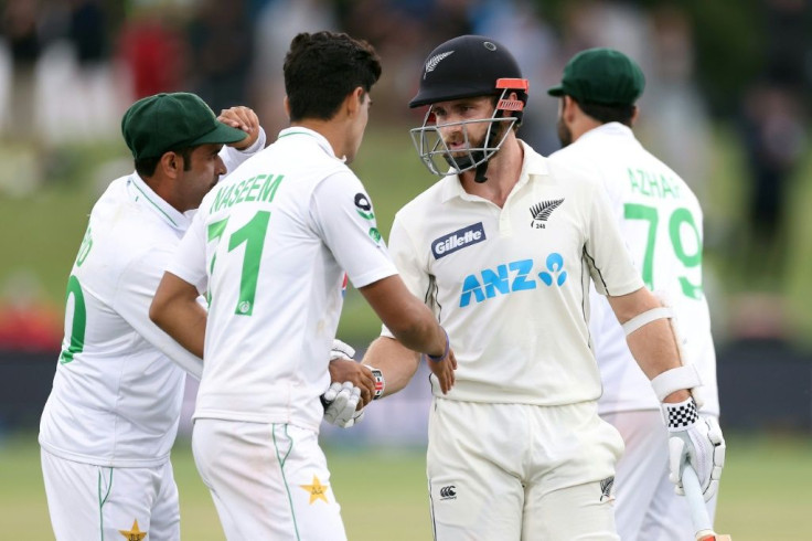 Pakistan's Abid Ali (left) and Naseem Shah congratulate Kane Williamson aftger he fell for 238
