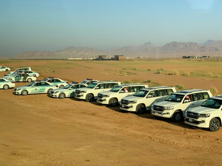 Saudi police vehicles wait at Al-Ula airport to escort visiting heads of state, including the Qatari emir, to the summit venue