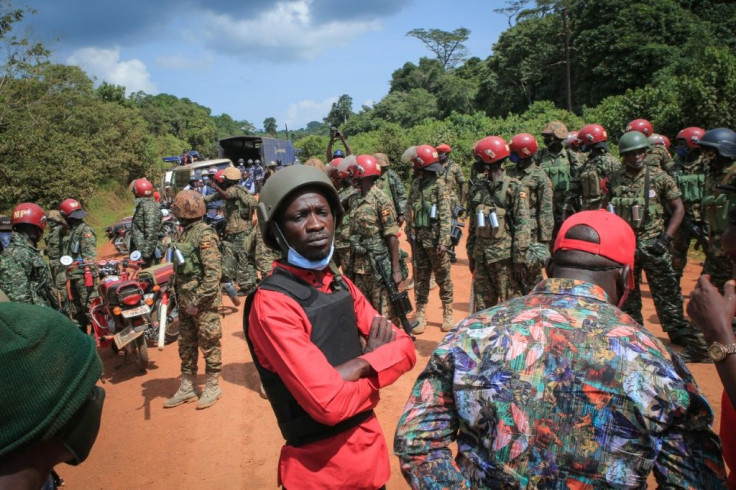 Campaign rallies for Bobi Wine (in red), have been broken up with tear gas and baton-wielding police on the pretence of protecting public health