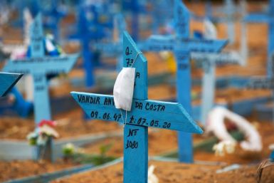 A face mask rests on a cross in an area reserved for the burial of COVID-19 victims at the Nossa Senhora Aparecida cemetery in Manaus, Brazil