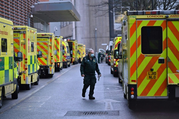 A paramedic is seen by a line of ambulances outside the Royal London Hospital as England begins a six-week lockdown