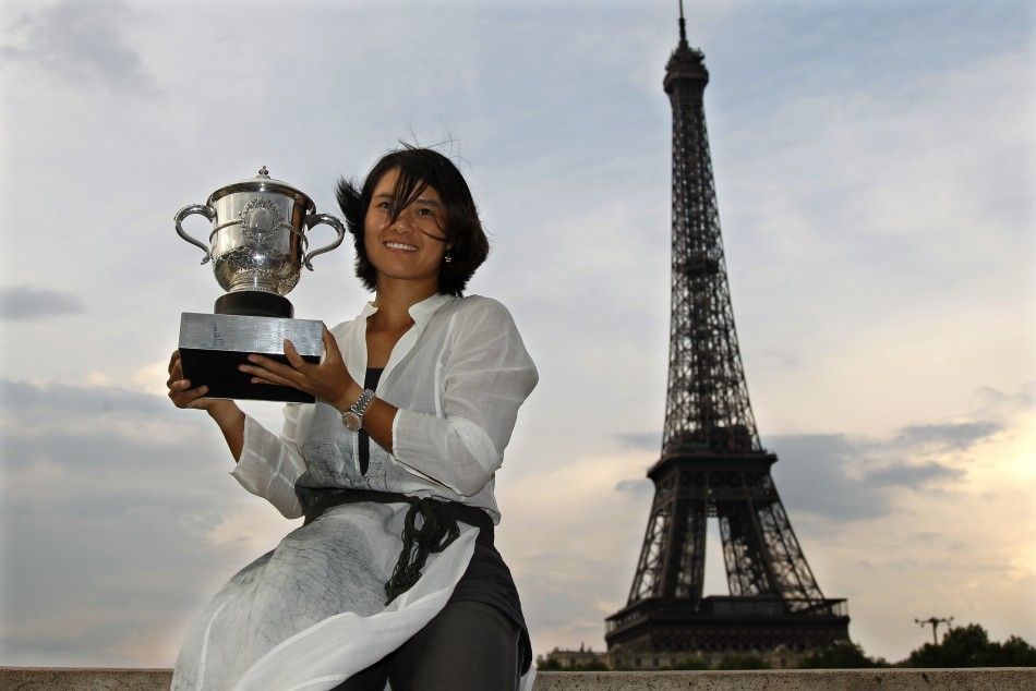 Li Na of China poses with her trophy near the Eiffel Tower in Paris after winning the French Open tennis tournament