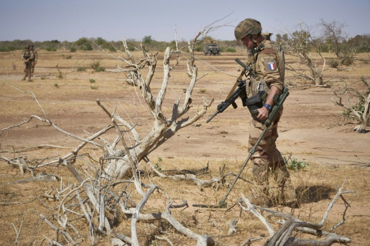 A French soldier on an exercise in Burkina Faso uses a bomb detector as he searches for a roadside device, one of the deadliest tactics used by jihadists