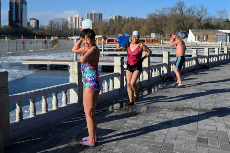 As the swimmers emerged from the lake, some doused themselves in warm water and watched the steam rise off their bodies