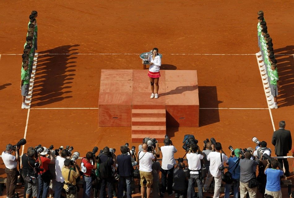 Li Na of China poses for the media with the trophy after winning her women039s final against Francesca Schiavone of Italy at the French Open tennis tournament at the Roland Garros stadium in Paris.