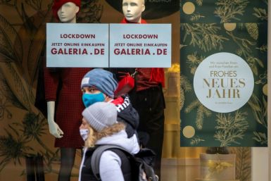 A sign in a German store window invites customers to shop online due to the coronavirus lockdown