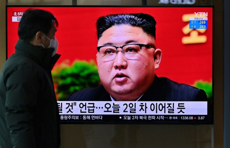 A man watches a television screen showing news footage of North Korean leader Kim Jong Un attending the 8th congress of the ruling Workers' Party held in Pyongyang, at a railway station in Seoul on January 6, 2021