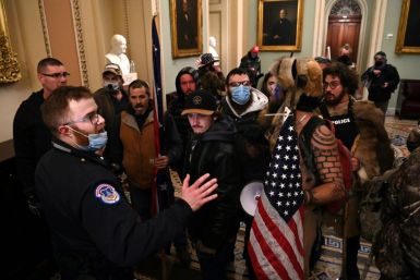 Supporters of US President Donald Trump confront Capitol police officers at the US Capitol on January 6, 2021, in Washington aiming to derail the certification of the November election results