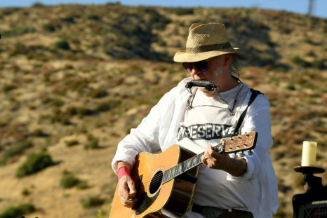 Neil Young, shown here performing in 2019, is selling a 50 percent stake in his song catalog