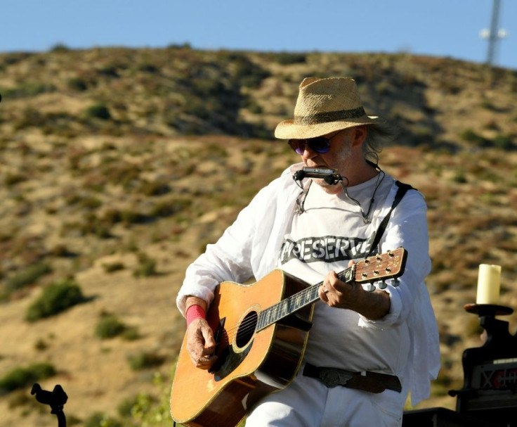Neil Young, shown here performing in 2019, is selling a 50 percent stake in his song catalog