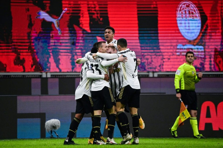 Juventus players celebrate after ending AC Milan's 27-match unbeaten run.