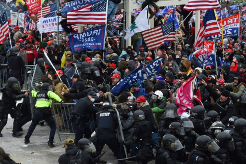 Trump supporters clash with police and security forces as they push barricades to storm the US Capitol in Washington D.C