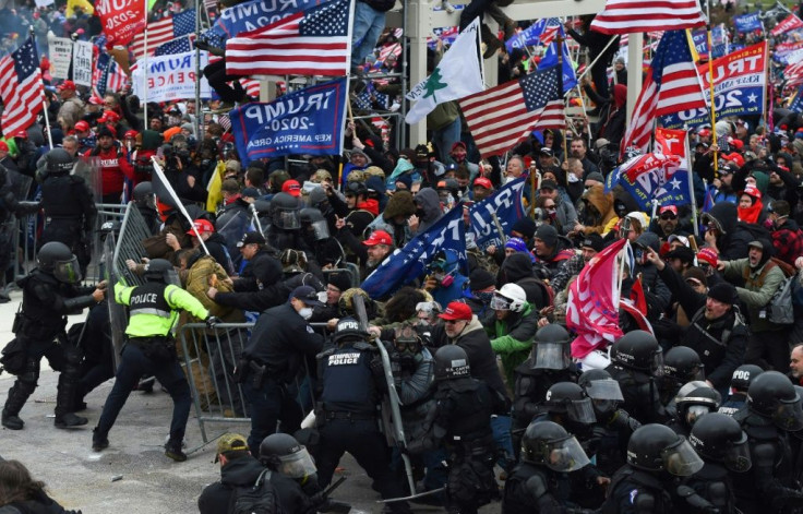 Trump supporters clash with police and security forces as they push barricades to storm the US Capitol in Washington D.C