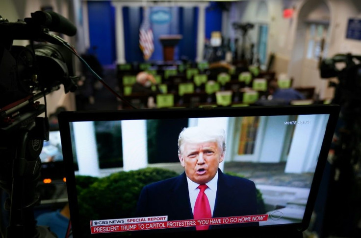 US President Donald Trump is seen on TV from a video message released on Twitter which was later taken down by the platform for breaking its rules