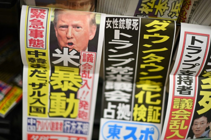 A Japanese newspaper on sale at a convenience store in Tokyo has a headline reading "US riot"