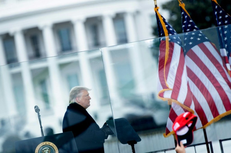 US President Donald Trump whips up the crowd from behind bullet proof glass outside the White House