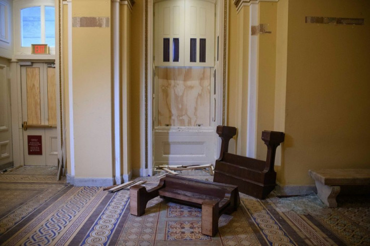 Overturned furniture and broken glass litter a hallway of the US Capitol after the crowd invasion