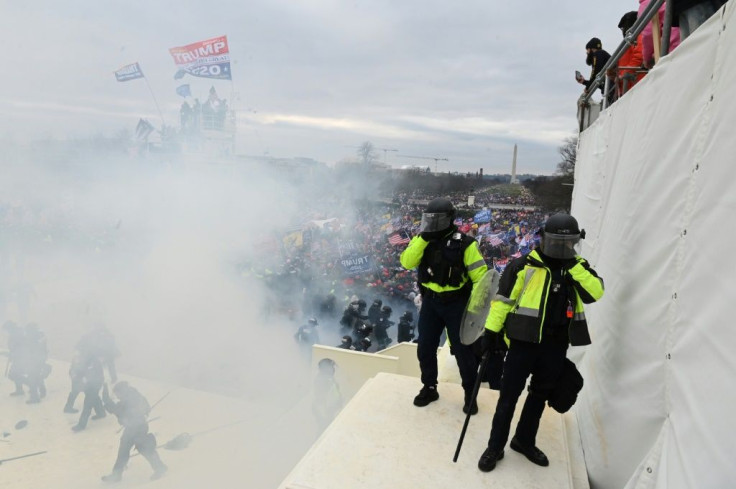 Tear gas fills the air as supporters of US President Donald Trump protest outside the US Capitol before breaking down barriers and entering the building