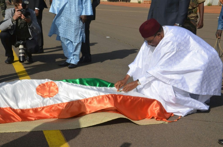 Mourning: Issoufou bows before the remains of soldiers killed in a jihadist attack on a base in Tillaberi, western Niger, in December 2019. Seventy-one died