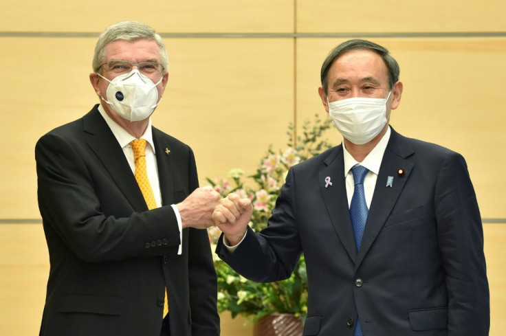 Japan's Prime Minister Yoshihide Suga (R) met International Olympic Committee president Thomas Bach (L) in Tokyo in November