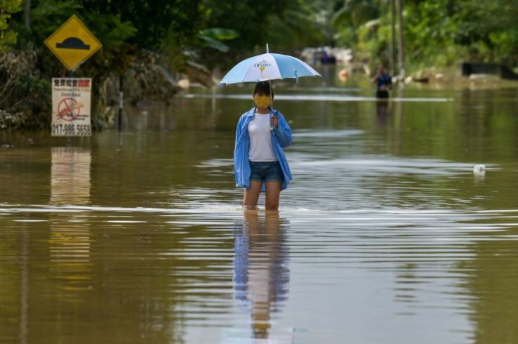 Monsoon rains on the east coast of Malaysia have caused flooding and forced almost 50,000 people to evacuate