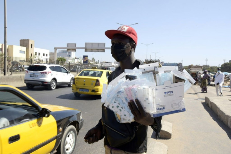 A vendor sells face masks on the street in Dakar, Senegal. Africa was spared the worst of the pandemic's first wave, but has seen a sharp surge in recent weeks