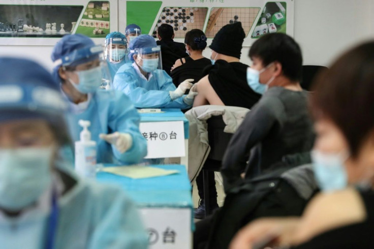 People receive vaccines against the Covid-19 coronavirus at a temporary vaccination centre in Beijing