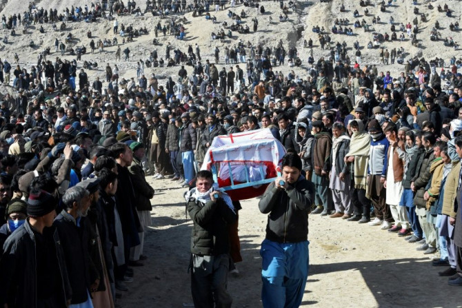 Mourners from the Shiite Hazara community carry the coffin of a miner killed in an attack by gunmen in Balochistan, Pakistan