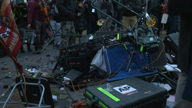 Supporters of Donald Trump smash media equipment and scream at journalists next to the US Capitol after protesters stormed the building