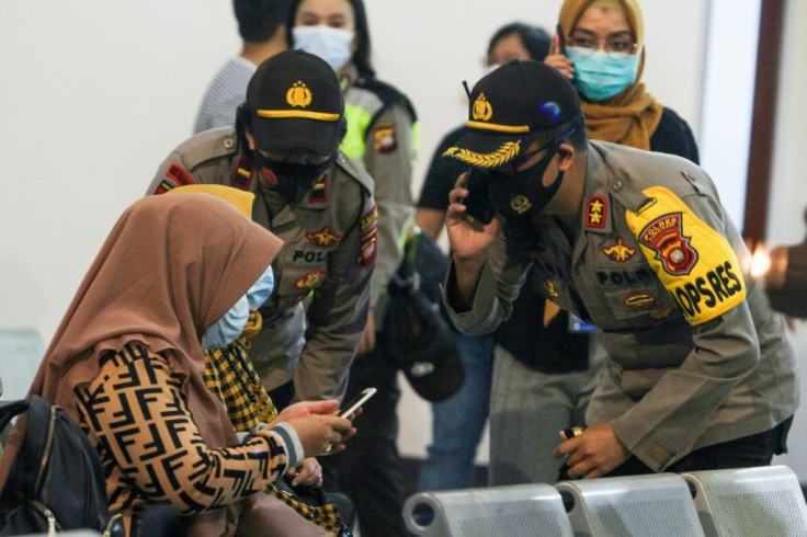 Relatives of passengers on missing Sriwijaya Air flight SJY182 wait for news at Supadio airport in Pontianak on January 9, 2021, after contact with the aircraft was lost shortly after takeoff from Jakarta