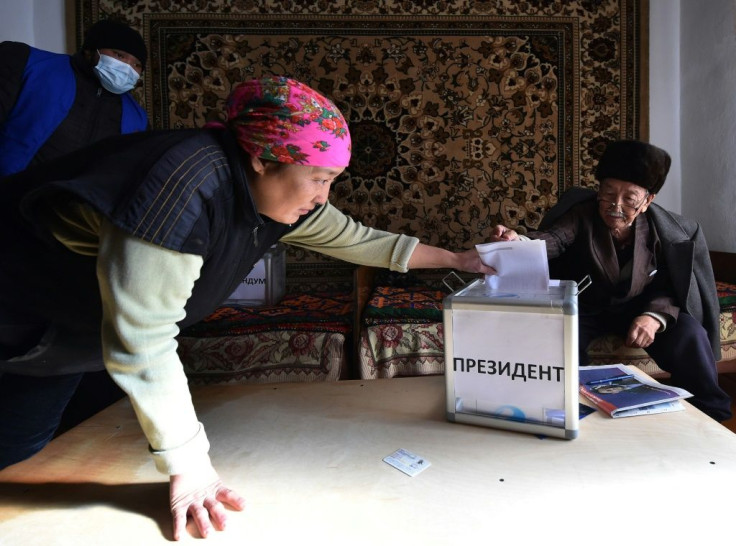 A woman casts her ballot during early voting in Arashan, outside Bishkek, as Kazakhs embark on their first elections since a political crisis embroiled the ex-Soviet country in October