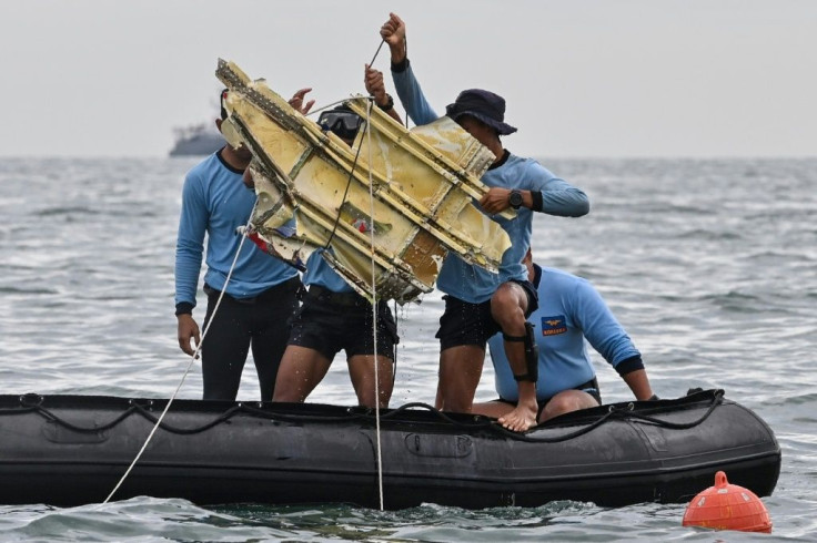 A piece of wreckage is pulled from the sea