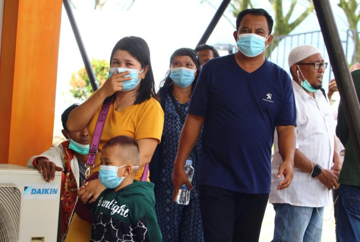 Family members gather at the airport in Pontianak