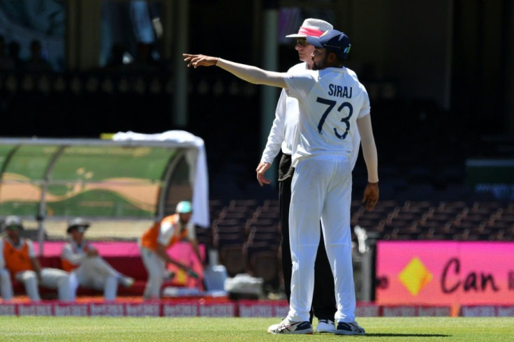 India's Mohammed Siraj points out to umpire Paul Reiffel where he thought he heard something said in the crowd, just before the tea break on Sunday