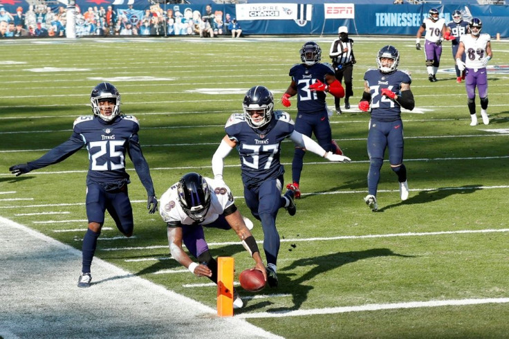 Baltimore quarterback Lamar Jackson dives in for a touchdown as the Ravens defeat the Tennessee Titans 20-13 in the NFL playoffs