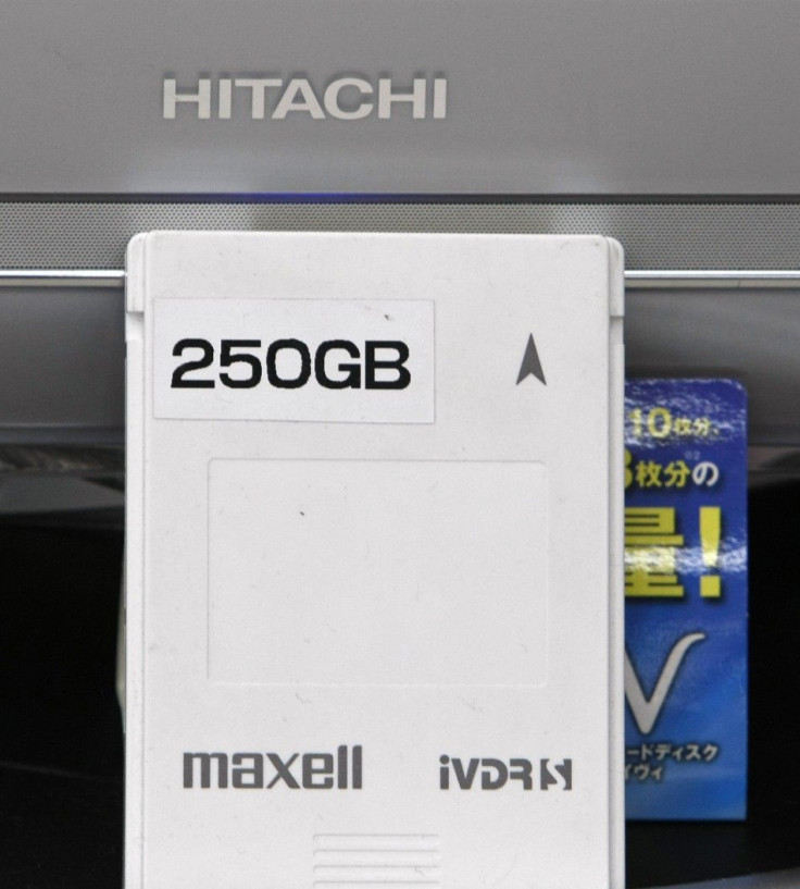 A Hitachi Maxell hard disc for Super Hi-Vision television is displayed in front of a Hitachi television set at an electronic shop in Tokyo