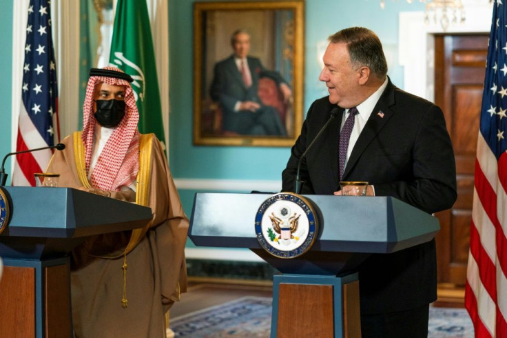 Secretary of State Mike Pompeo glances to Saudi Foreign Minister Prince Faisal bin Farhan Al Saud at the State Department in October 2020