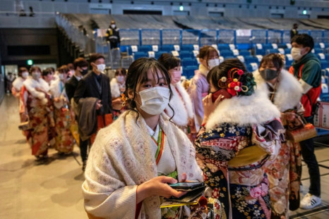 Twenty-year-old women dressed in kimono attend a "Coming-of-Age Day" celebration ceremony at Yokohama Arena in Yokohama on January 11, 2021 under a state of emergency over the Covid-19 coronavirus pandemic.